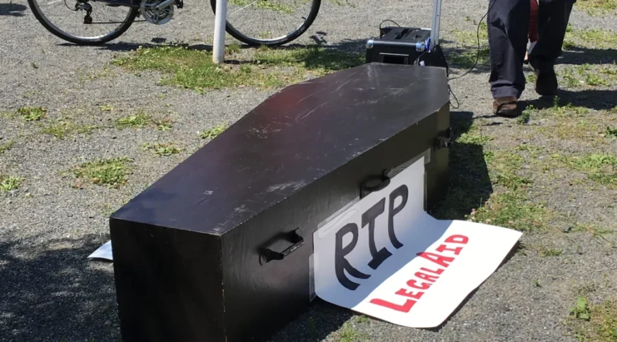 Mock Funeral Held For Legal Aid