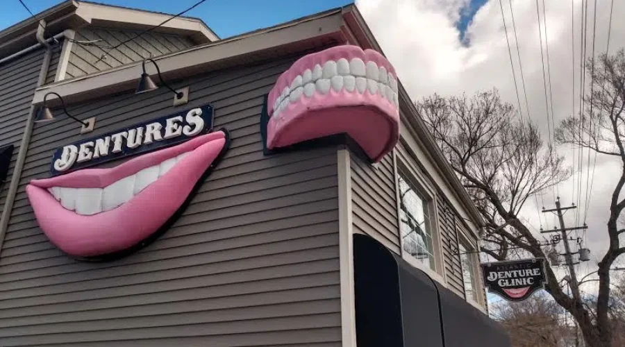 Police Tear Down Signs On Denture Clinic