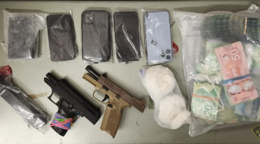 Guns, drugs, and $25k cash seized during police searches