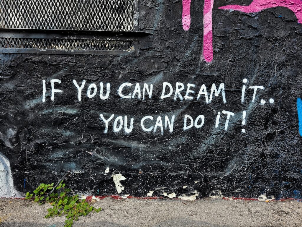 graffiti on a wall that says if you can dream it, you can do it
