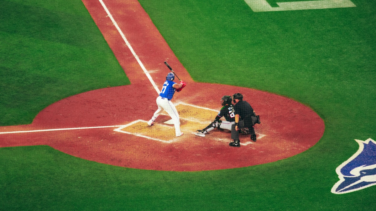 A baseball player holding a bat on top of a field