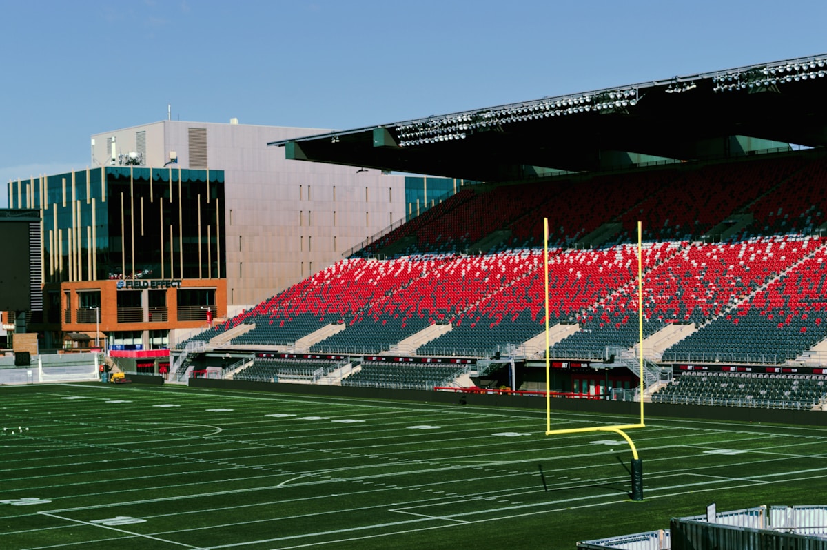 a stadium with a football field and empty seats