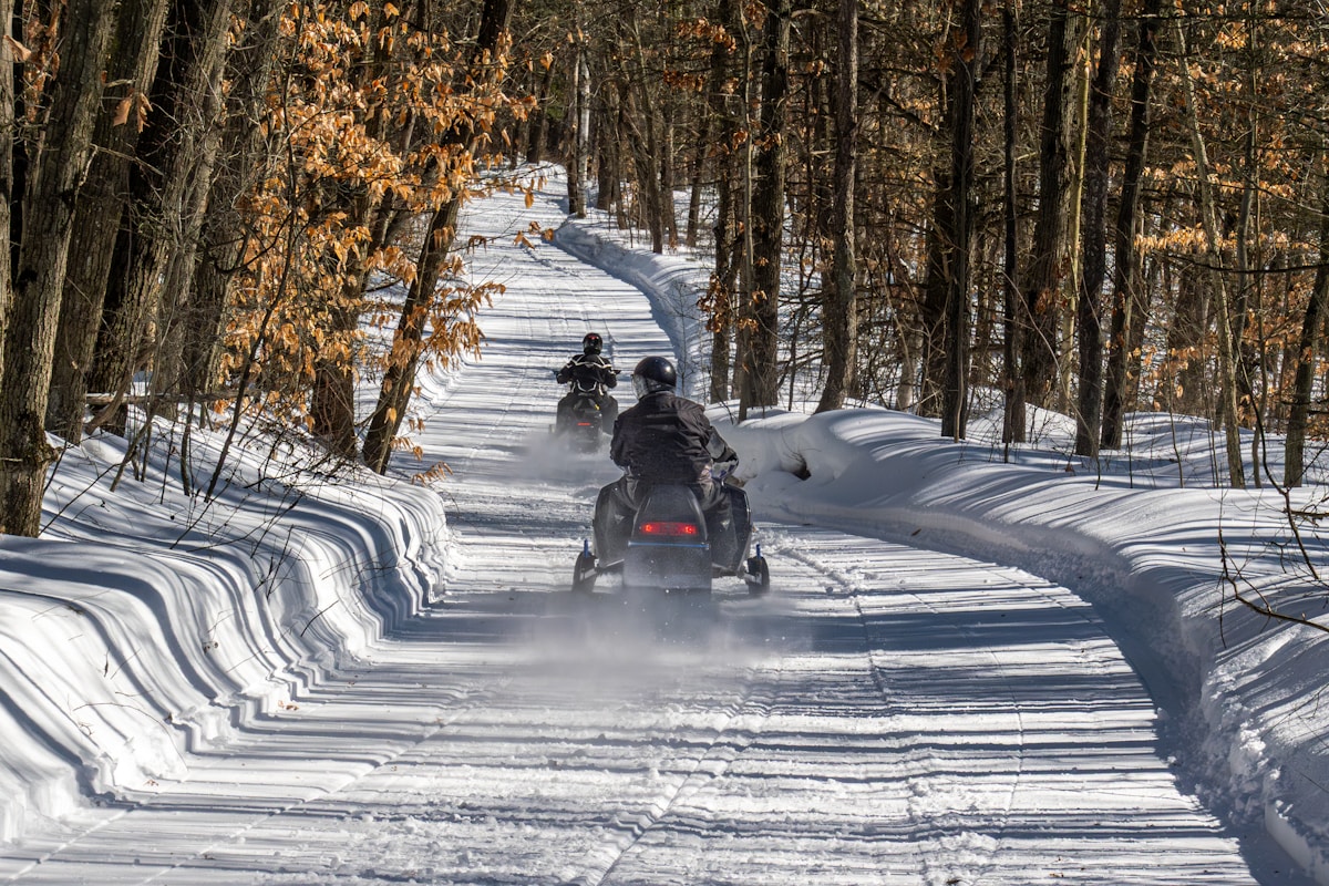 A group of people riding down a snow covered road