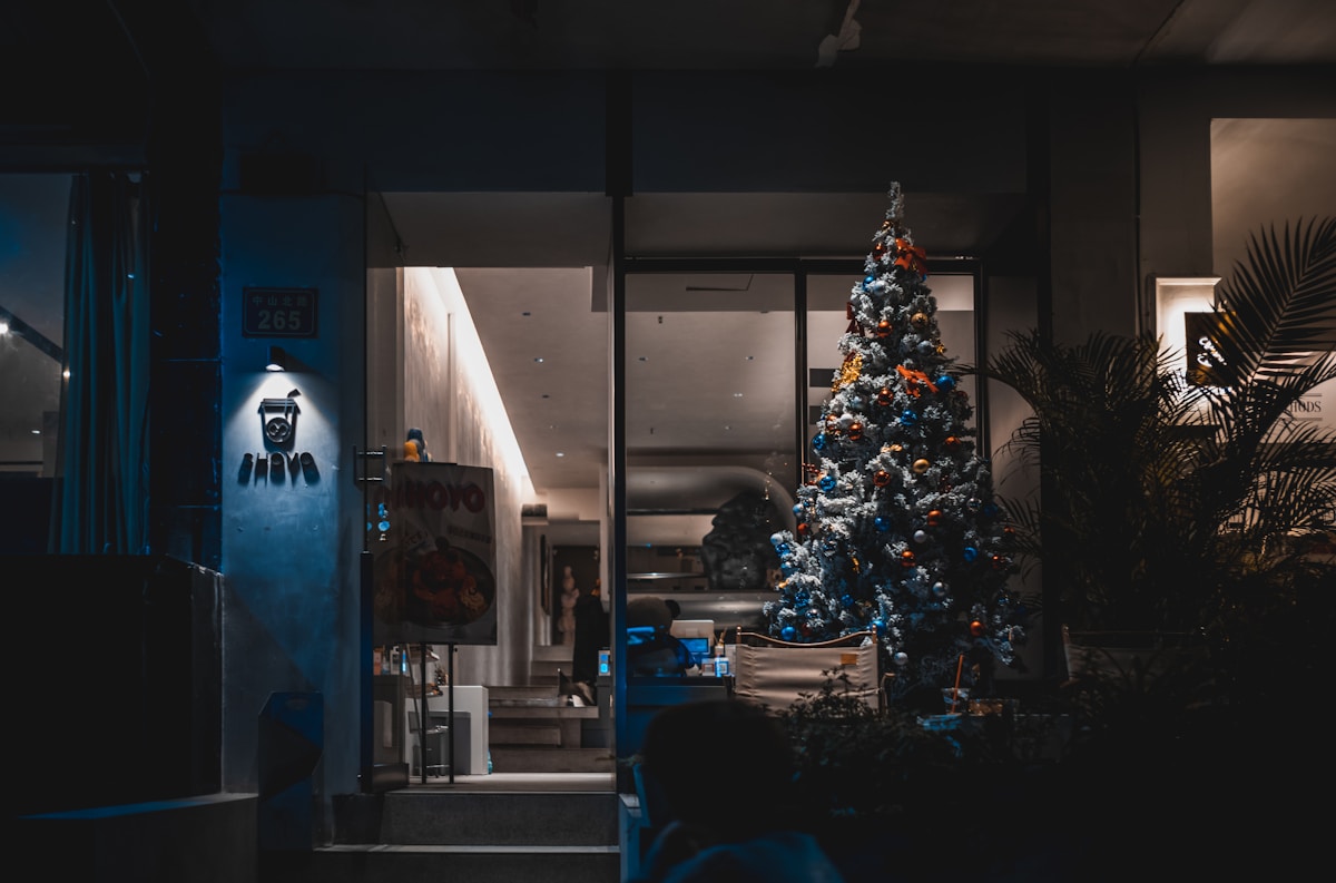 a christmas tree is lit up in a dark room