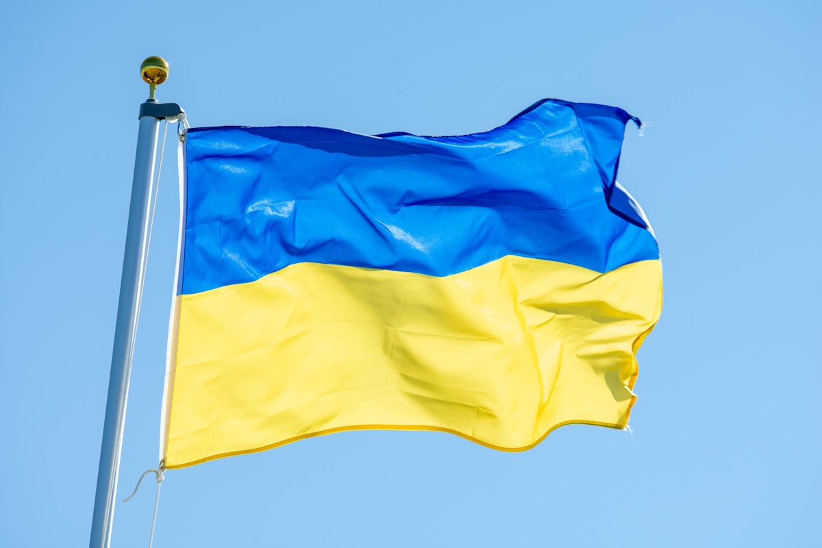 a blue and yellow flag flying in the wind