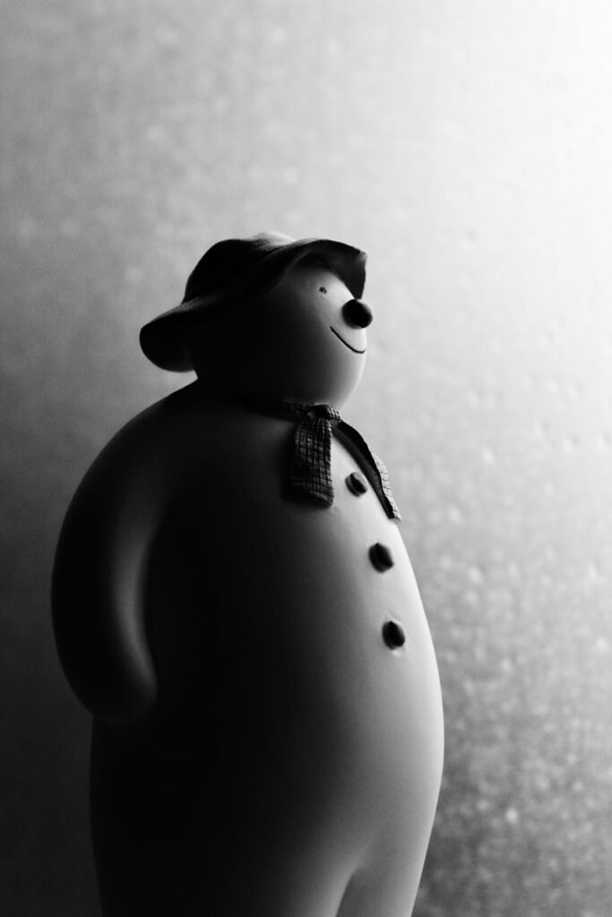 grayscale photography of snowman figurine