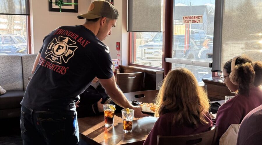 Off-duty firefighters serve at Boston Pizza for Toys for Tots campaign