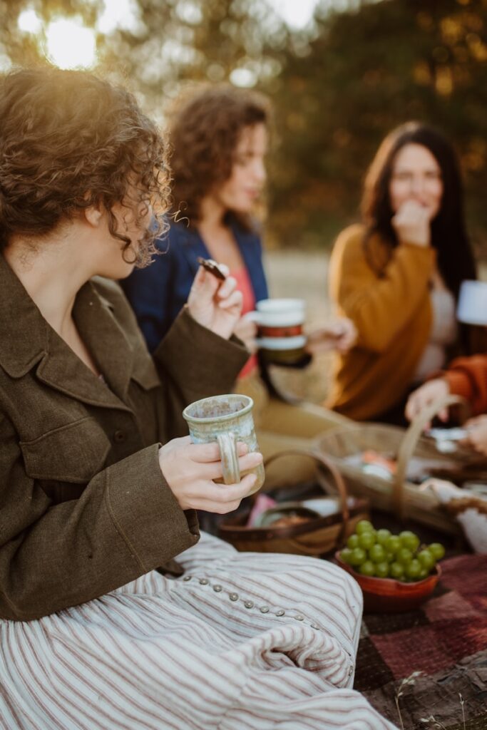 A group of women sitting around a picnic table