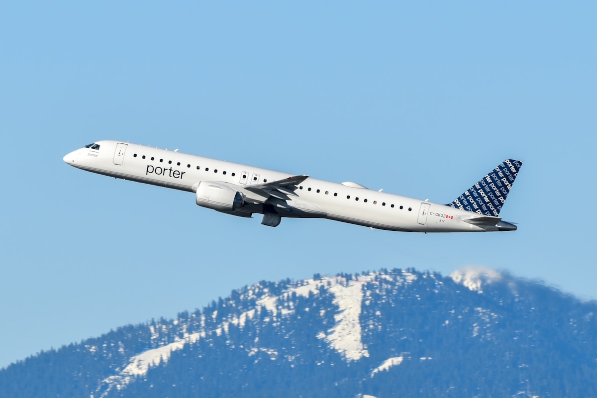 An airplane is flying over a mountain range