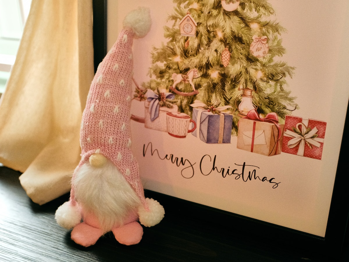 Pink gnome with christmas tree and gifts