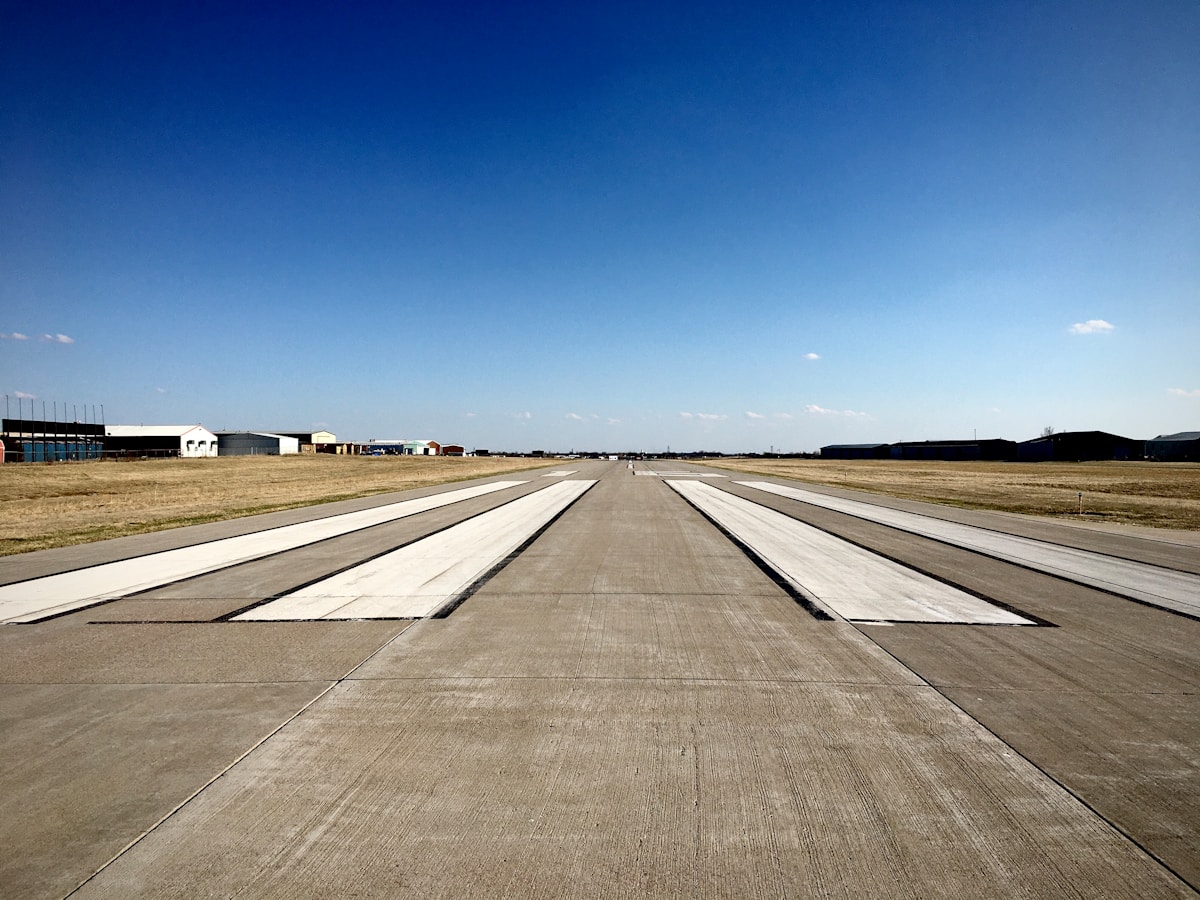 gray asphalt road under blue sky during daytime