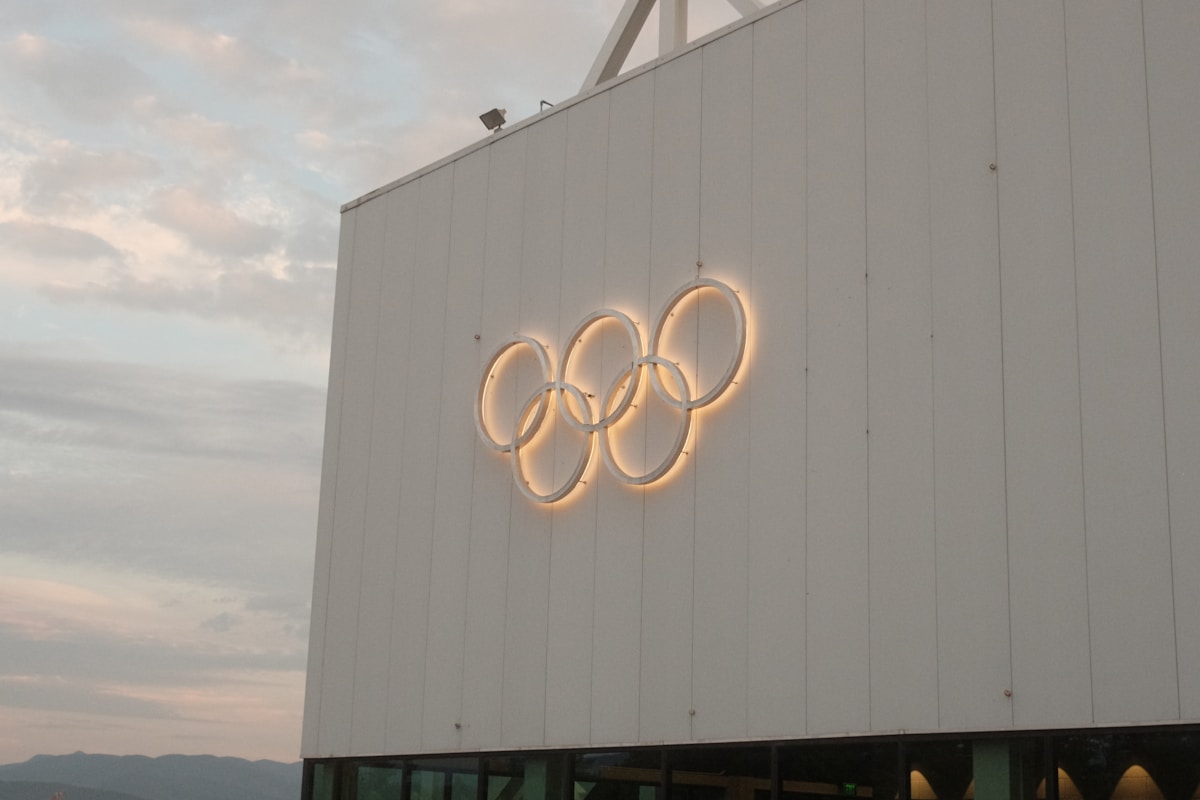 White building with illuminated olympic rings symbol