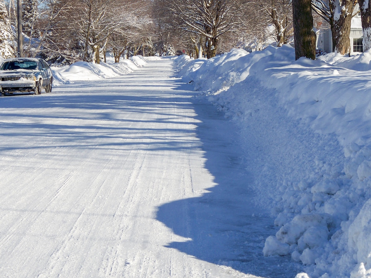 a car driving down a snow covered road