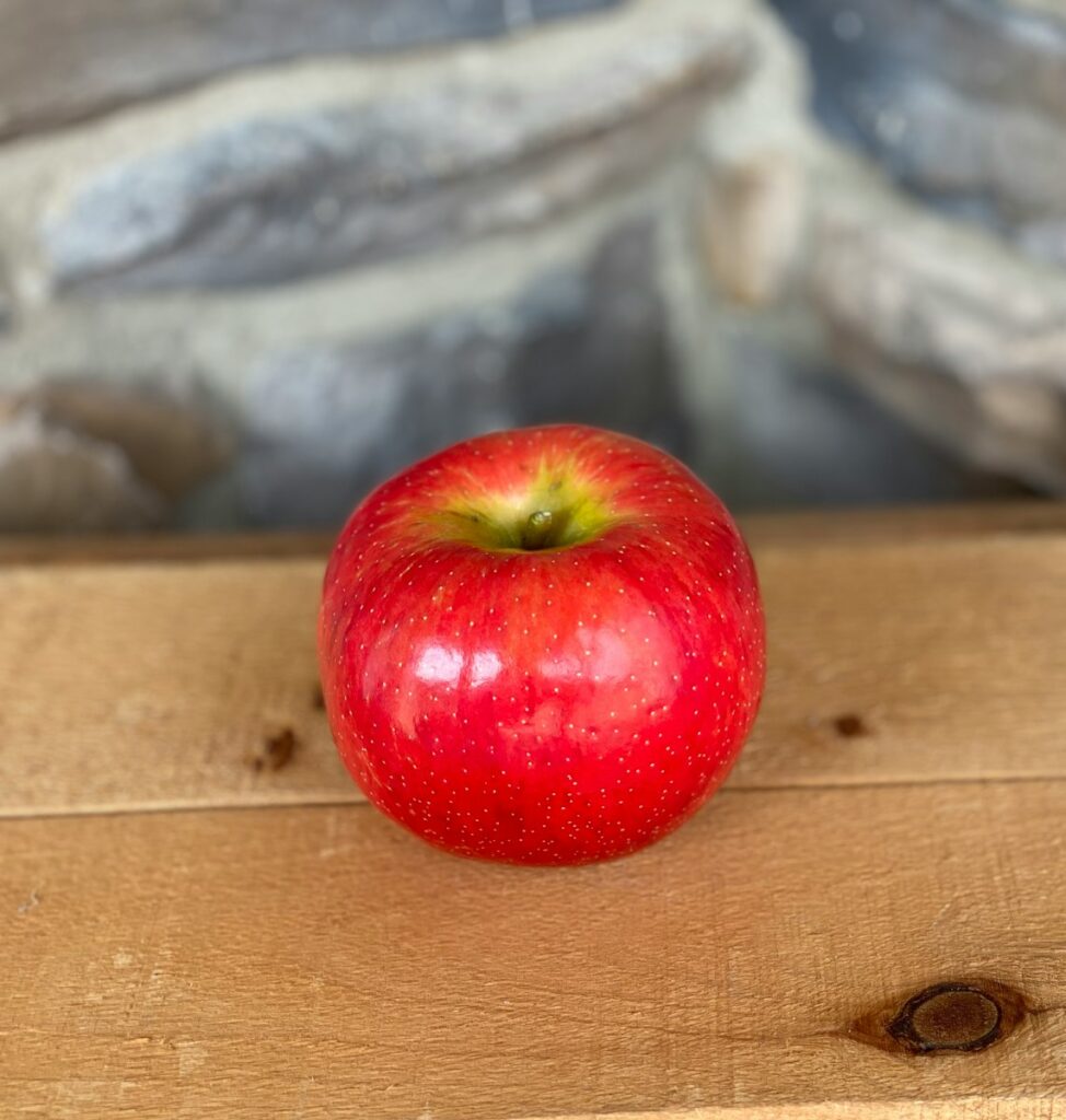 red apple fruit on brown wooden table