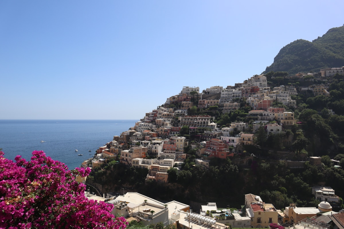 a view of a village on a cliff overlooking the ocean