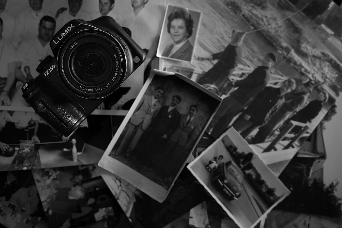 A camera rests amidst old photographs.