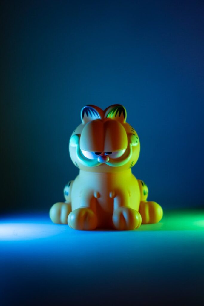a small toy tiger sitting on a blue surface