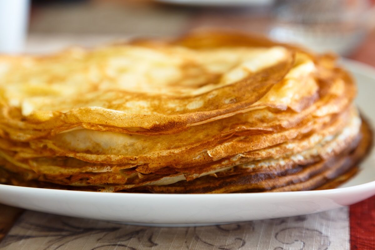 a stack of pancakes sitting on top of a white plate