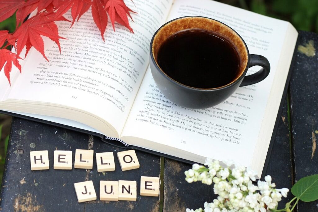 a cup of coffee sitting on top of a table next to a book